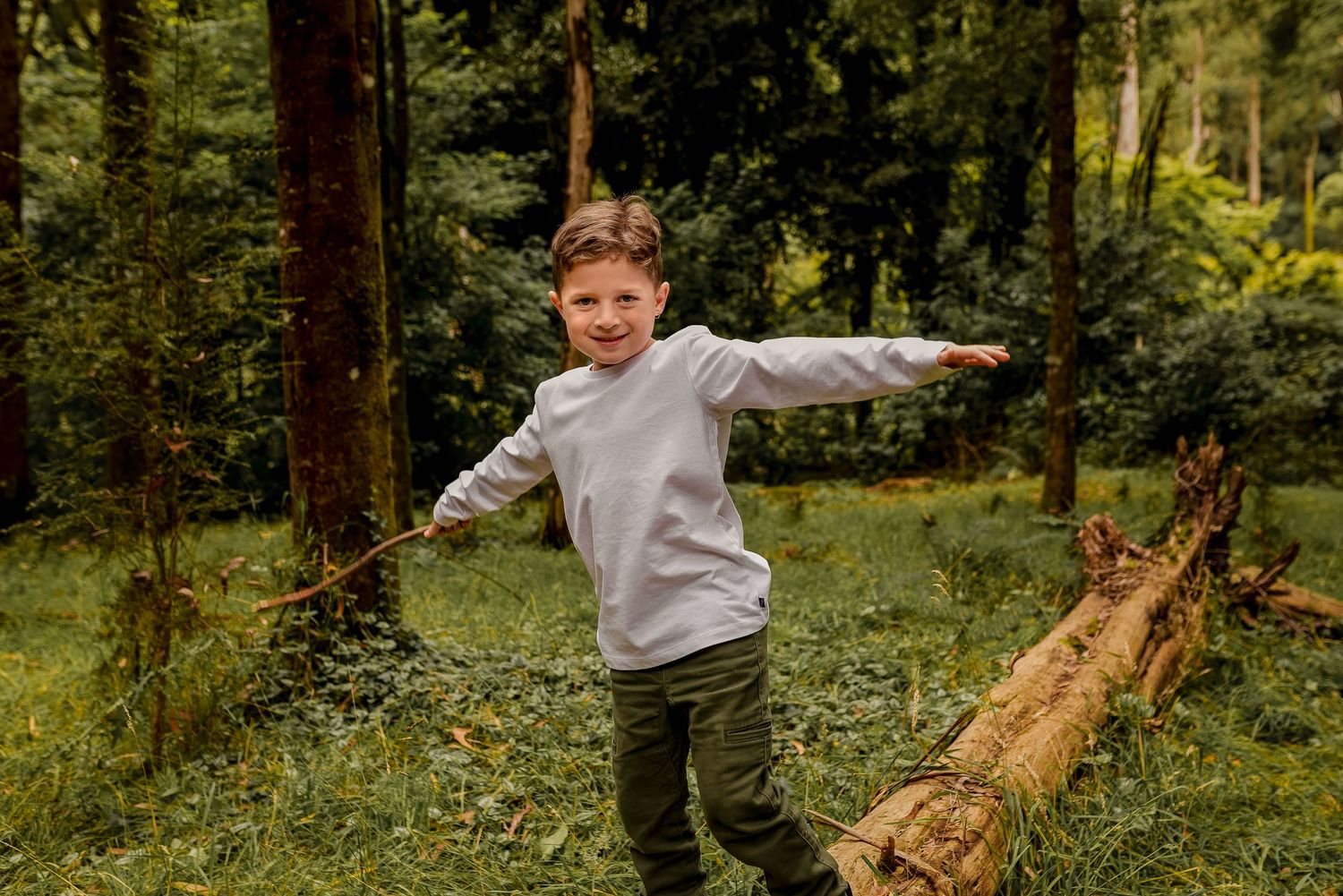 Boy balancing on log during photoshoot in Melbourne