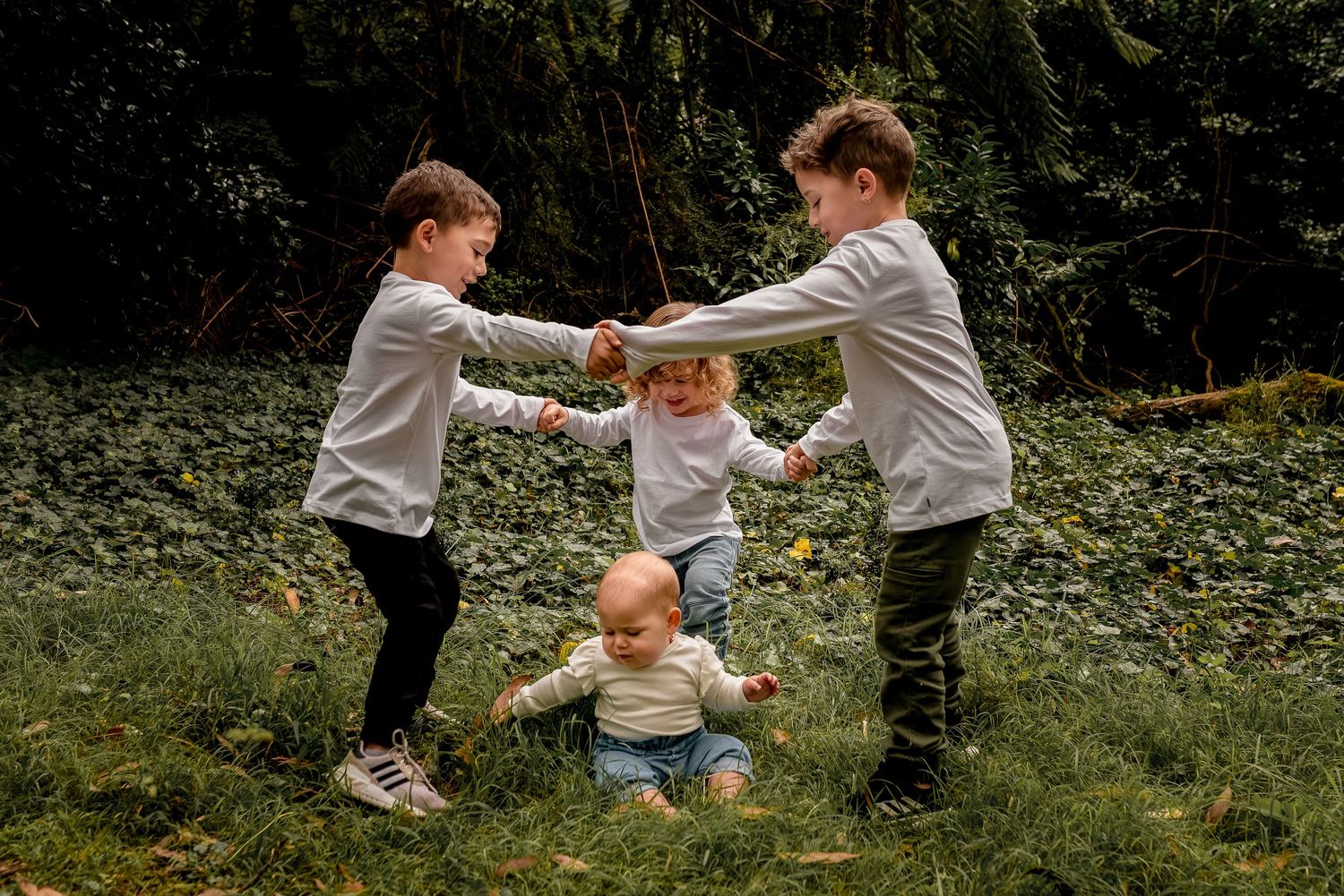Children playing ring-a-rosie during outdoor photoshoot