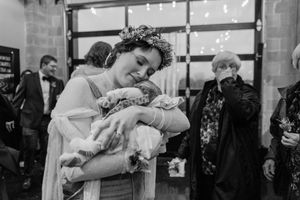 Wedding couple shares an intimate dance embrace in front of a crowd at their reception.