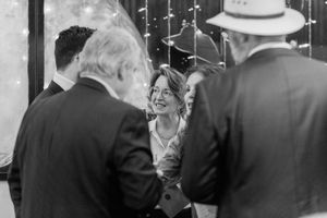 A series of black and white vintage candid photographs showing people in conversation at a social gathering.