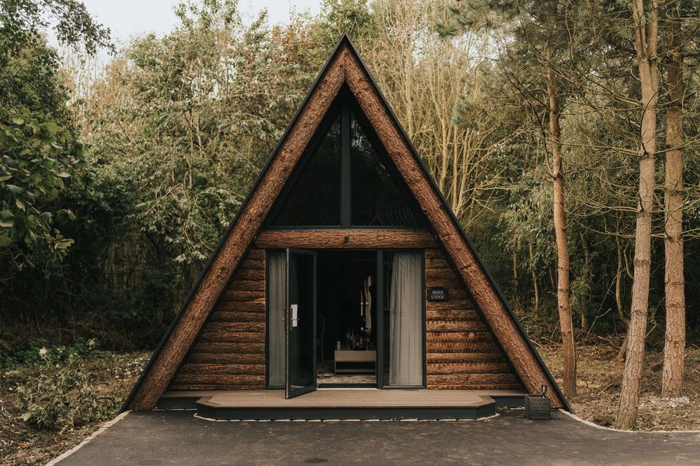 A-frame wooden cabin in a wooded forest setting with rustic architectural design at Grand Lodge Oaklands - taken by Grimsby photographer.