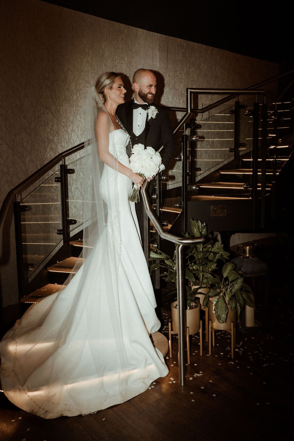 A bride and groom share an elegant moment on a staircase at Grand Lodge Oaklands - taken by Grimsby photographer.