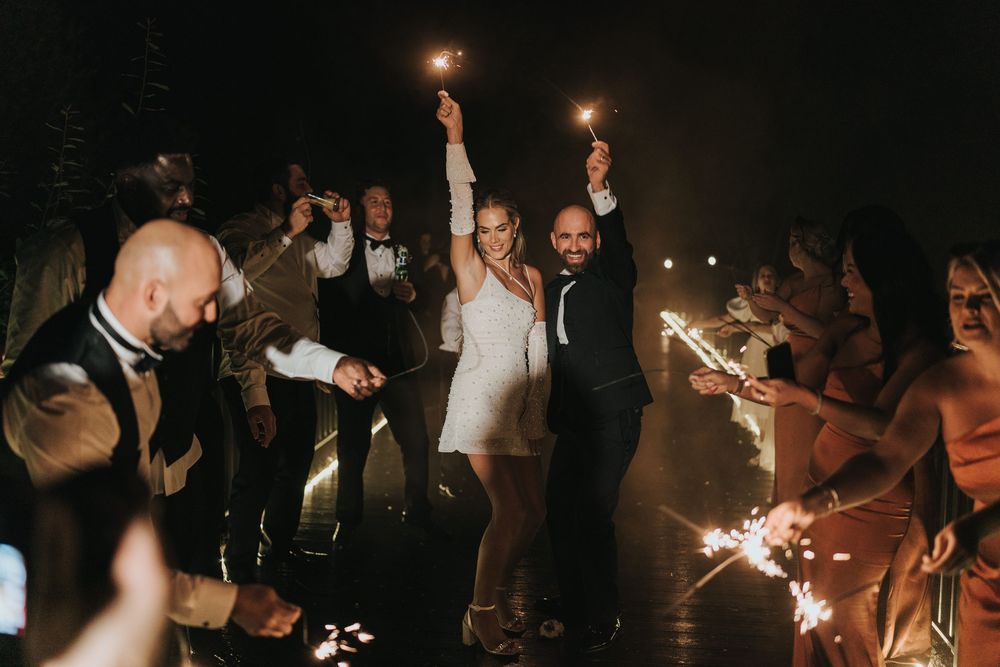 Wedding celebration at night with couple walking through sparklers held by guests at Grand Lodge Oaklands - taken by Grimsby photographer.