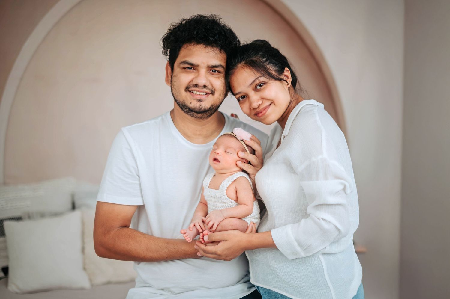 A collection of intimate family photos showing parents with their newborn baby in soft natural light.