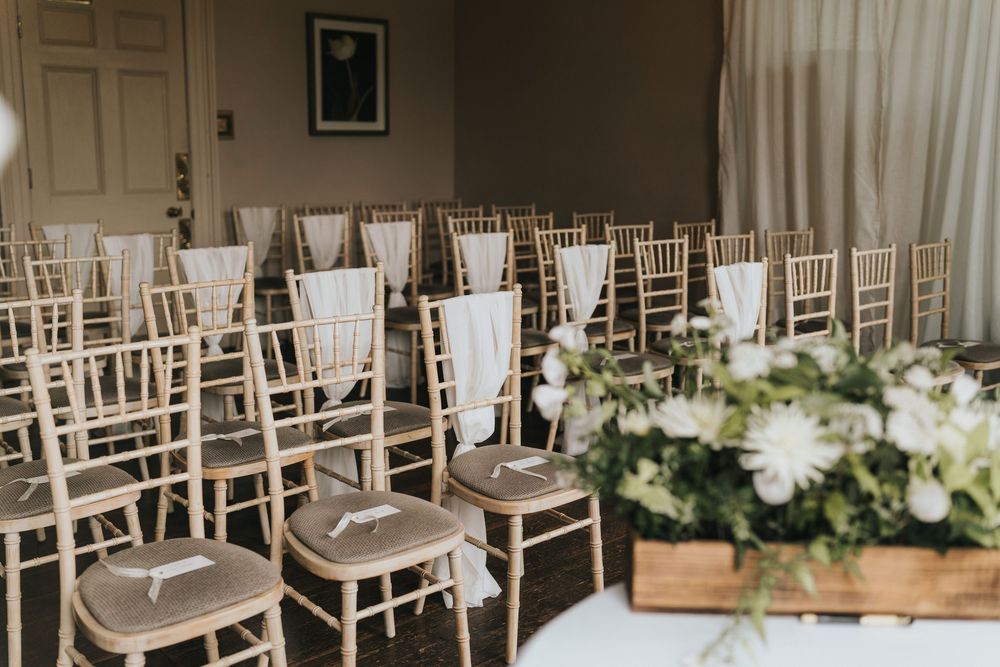 Elegant silver Chiavari chairs lined up for a wedding ceremony at Cleatham Hall.