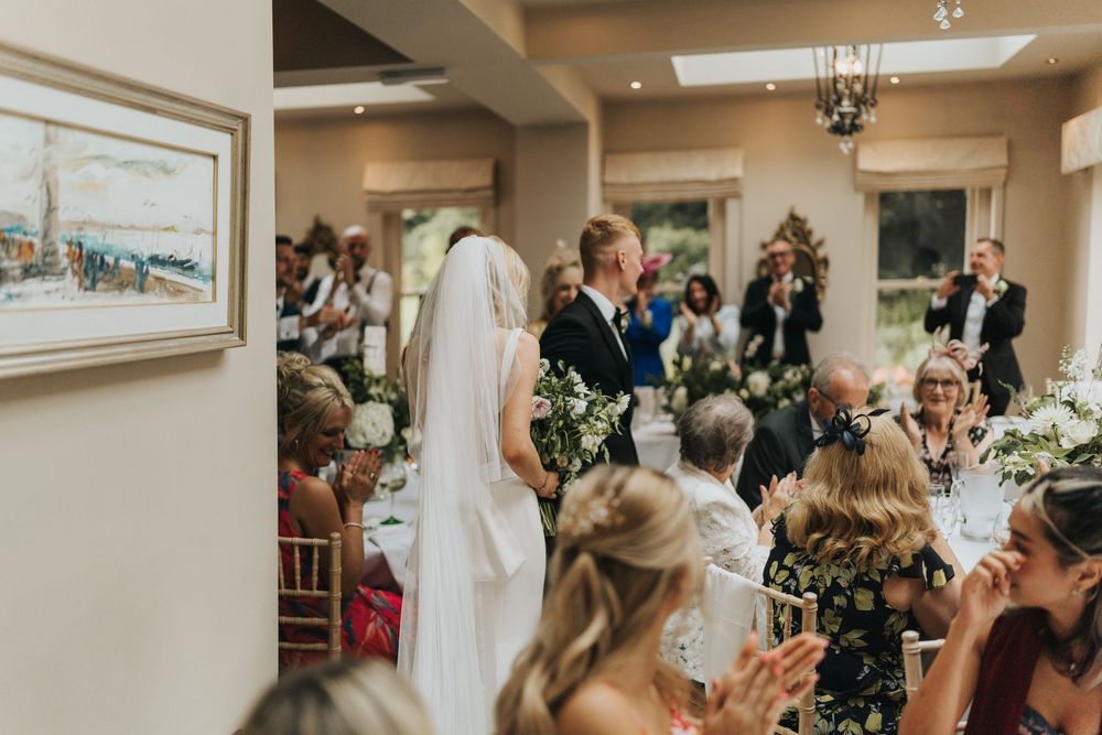 Happy guests dancing and celebrating at a joyful wedding reception in an elegant indoor venue at Cleatham Hall.