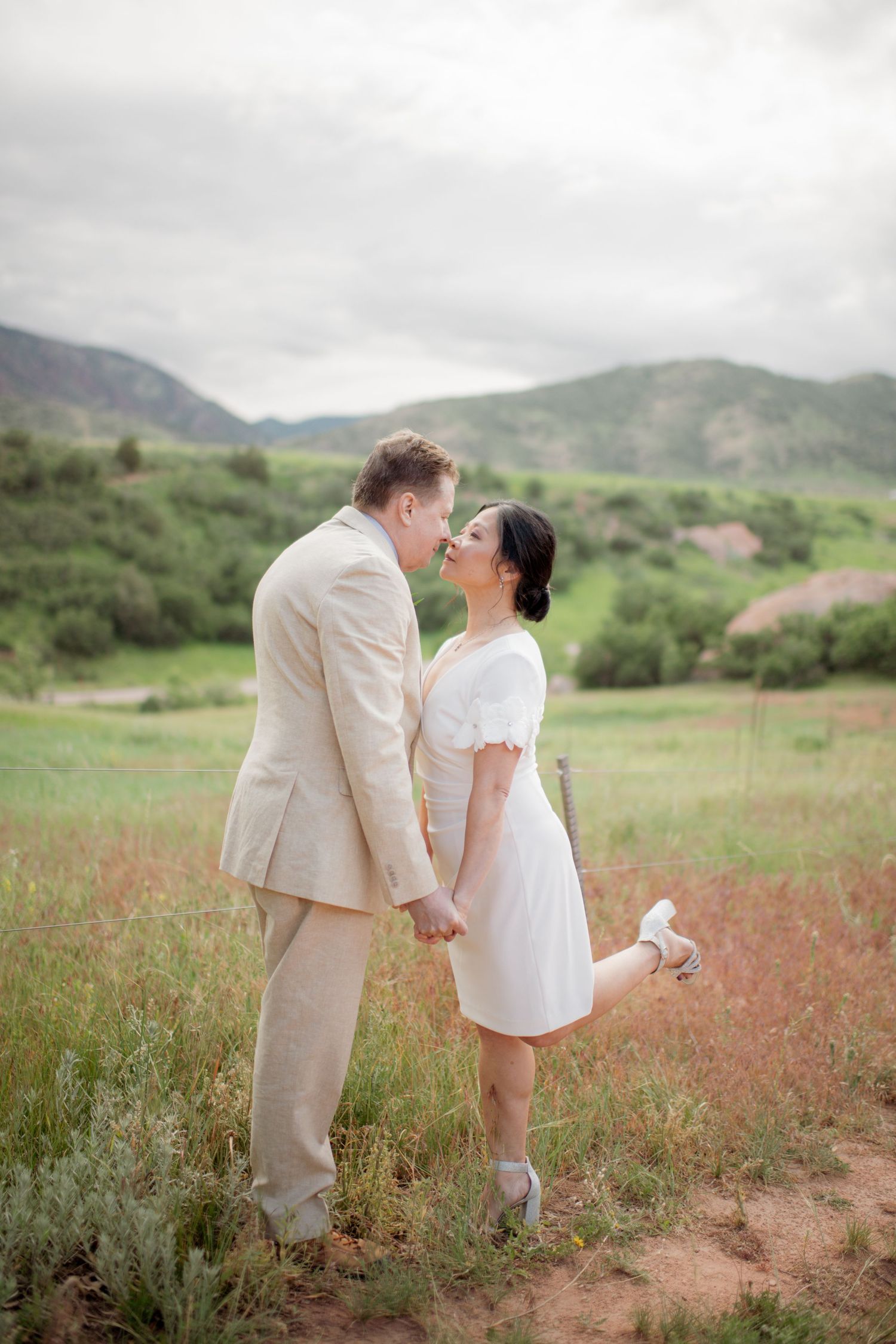 A series of black and white photos showing a stunning bridal gown with long train in an outdoor garden setting.