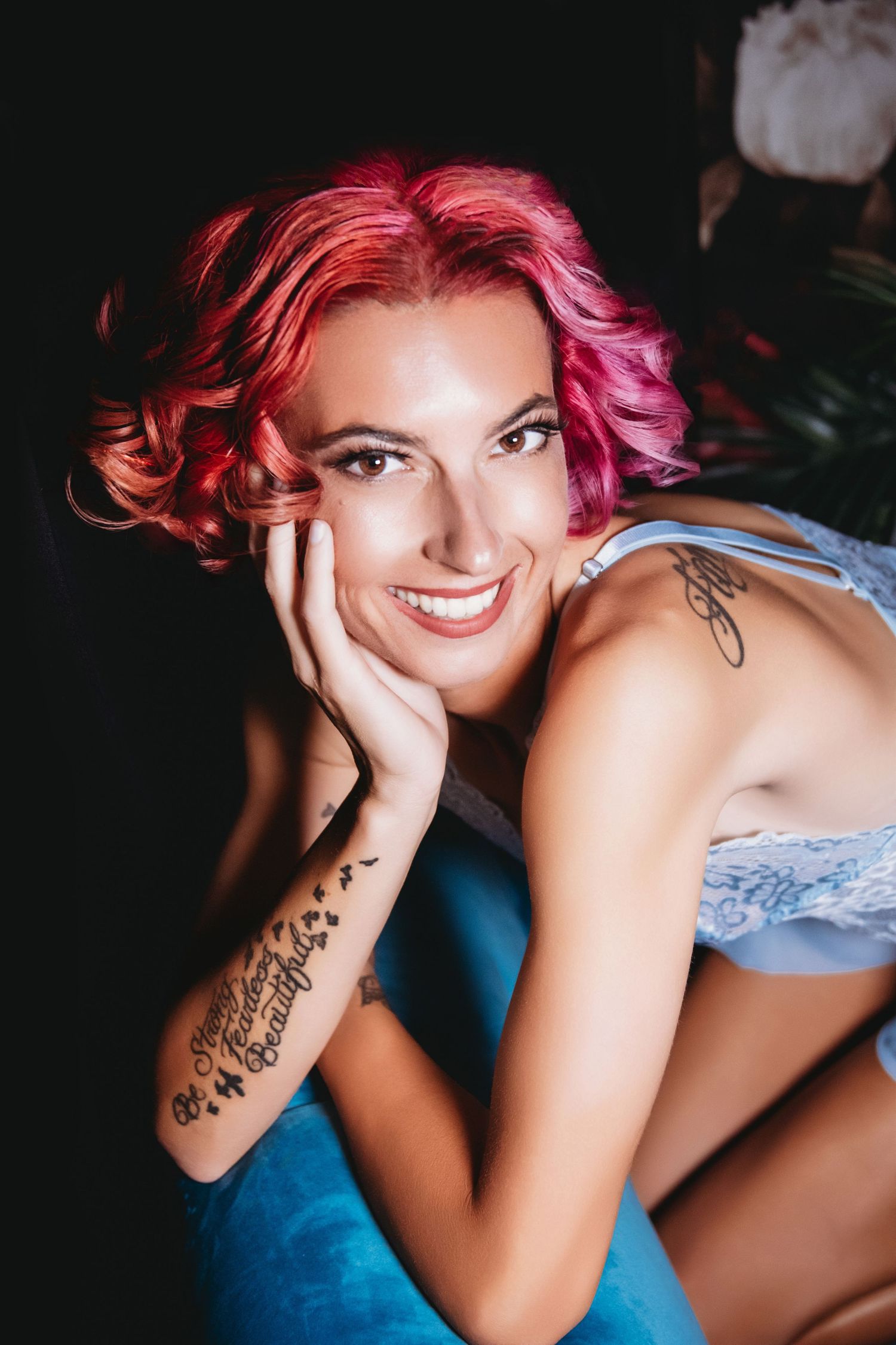 Curvy woman with pink hair and blue teddy smiling confidently | Playful, body-positive boudoir in Venice FL