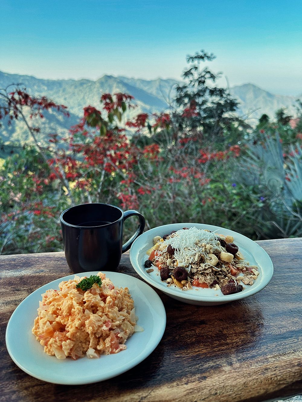 Breakfast cereals and scrambled eggs with a view over a stunning landscape.