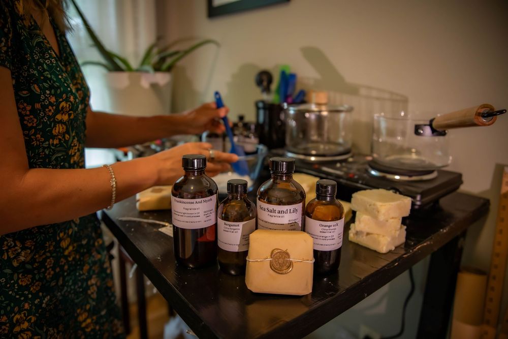Various glass bottles and ingredients arranged on a dark counter for mixing cocktails or beverages.