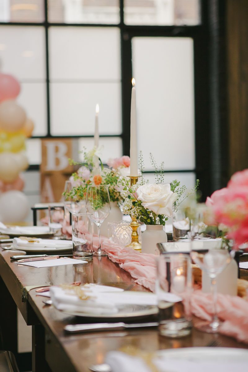Elegant table setting with floral arrangements at a Brooklyn Winery baby shower brunch, photographed by Paula Brearley.