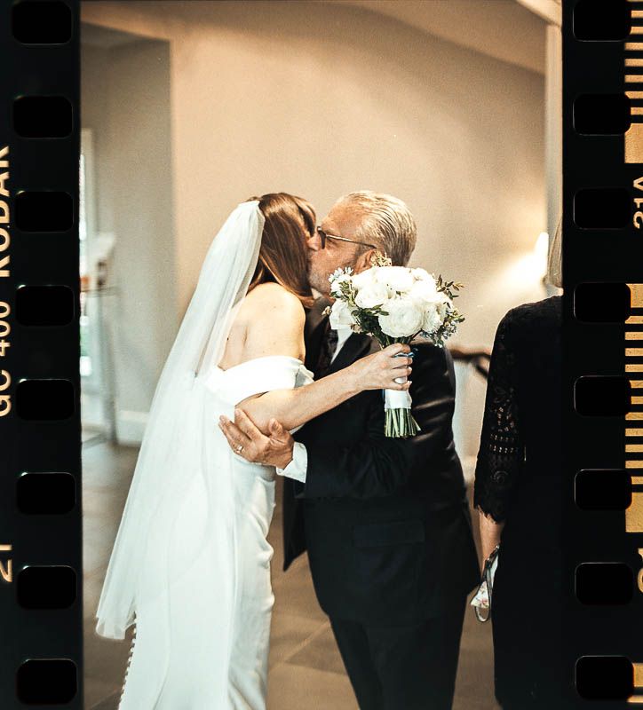 A romantic wedding moment captured with a bridal bouquet of white flowers in a soft, dream-like 35mm film photograph Pittsburgh PA 2025