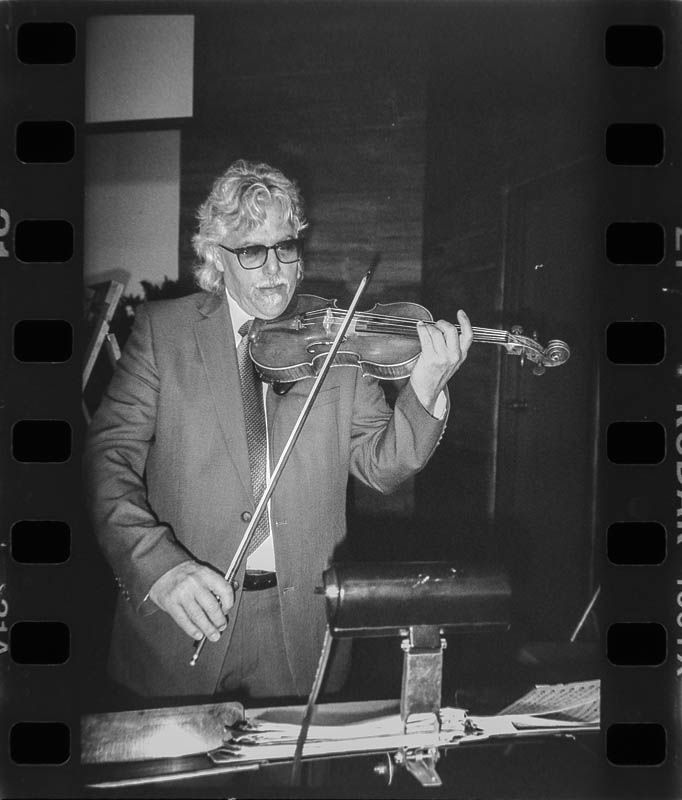 Black and white 35mm Film photo of a violinist performing for a wedding video near pittsburgh pa.