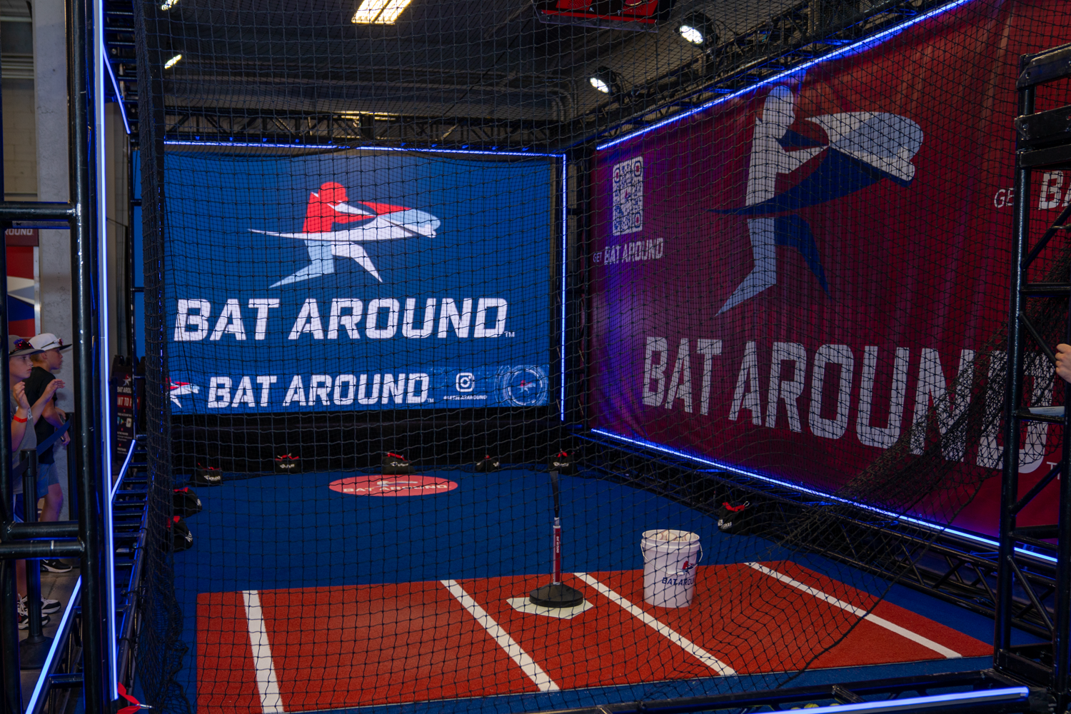 Gaming setup showing 'Bat Around' branding displayed on multiple screens in an arcade-style environment.