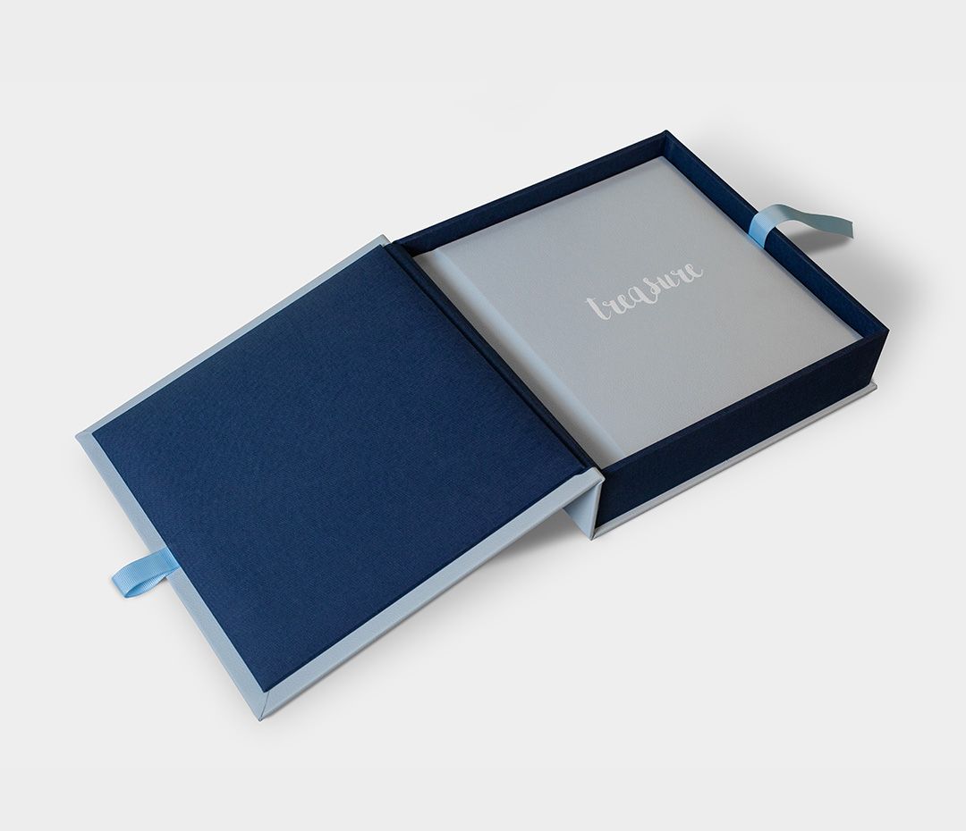 Elegant navy blue presentation box with sliding cover for a wedding album.