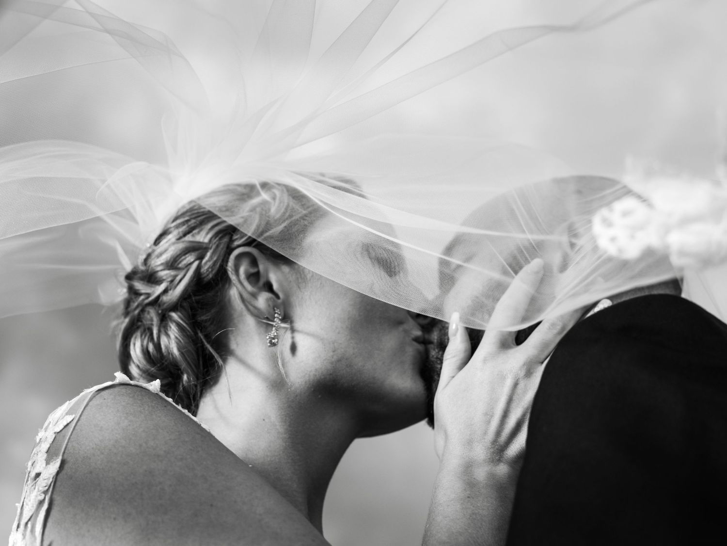 A romantic black and white portrait of a bride in her veil.