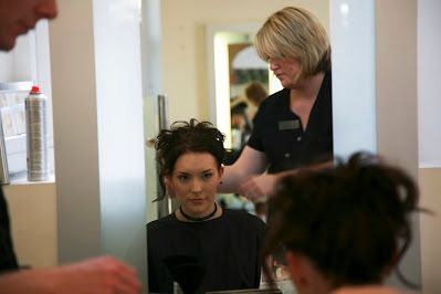 Professional hair styling session in progress at a modern salon.