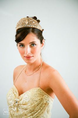 Close-up bridal portrait with crystal crown and gold beaded gown.