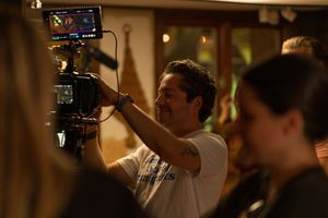 Filmmaker operating a professional camera rig during an indoor shoot.