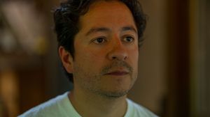 Behind the scenes shot of filmmaker in brown warm lighting on set.