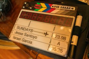 Close-up view of film production slate or clapperboard showing scene numbers and filming information.