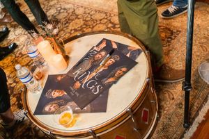 Close-up view of drum heads with artwork or signatures displayed on them.