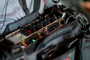 Close-up view of professional audio mixing equipment showing illuminated controls and faders.