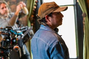 Film crew members working with camera equipment on a production set.