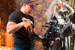 Behind-the-scenes photo shoot with professional photographers working in a studio with lighting equipment.