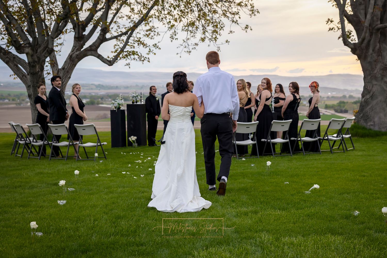 bride with man walking down aisle to give her away at Garman Hill at sunset