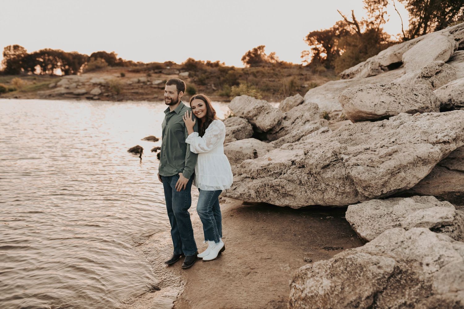 engaged couple snuggles on the lake at murrell park