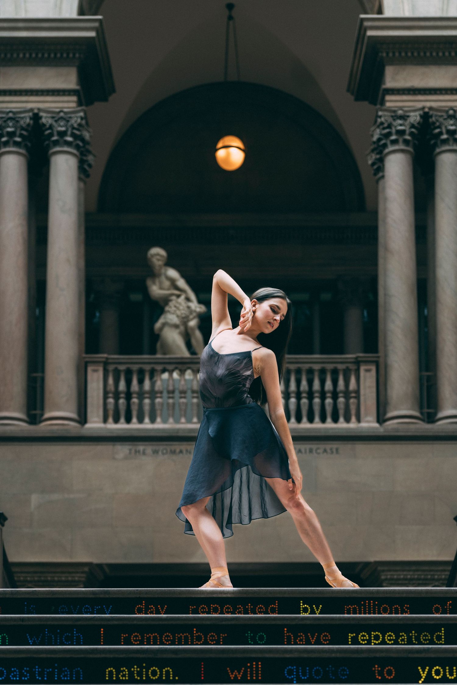 Tampa Florida Dance Photography of a ballerina standing on pointe on stairs in downtown Tampa in pointe shoes and leotard