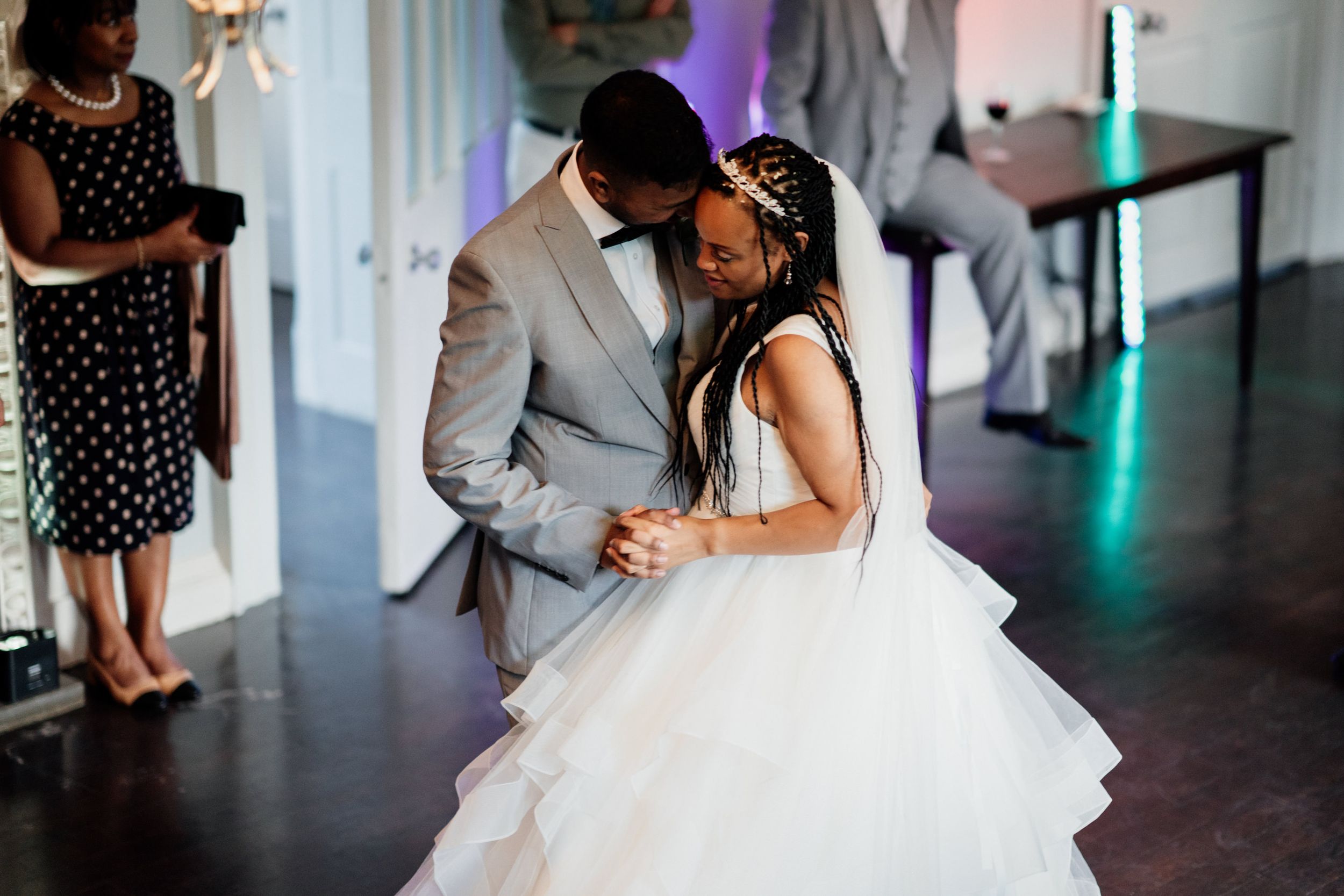 A tender moment on the dance floor as newlyweds share their first dance at an elegant wedding reception.