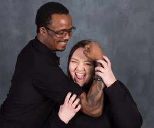 Joyful and candid moment captured between two people in a studio setting.