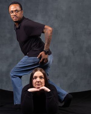 Artistic studio portrait with dynamic pose composition against gray backdrop.