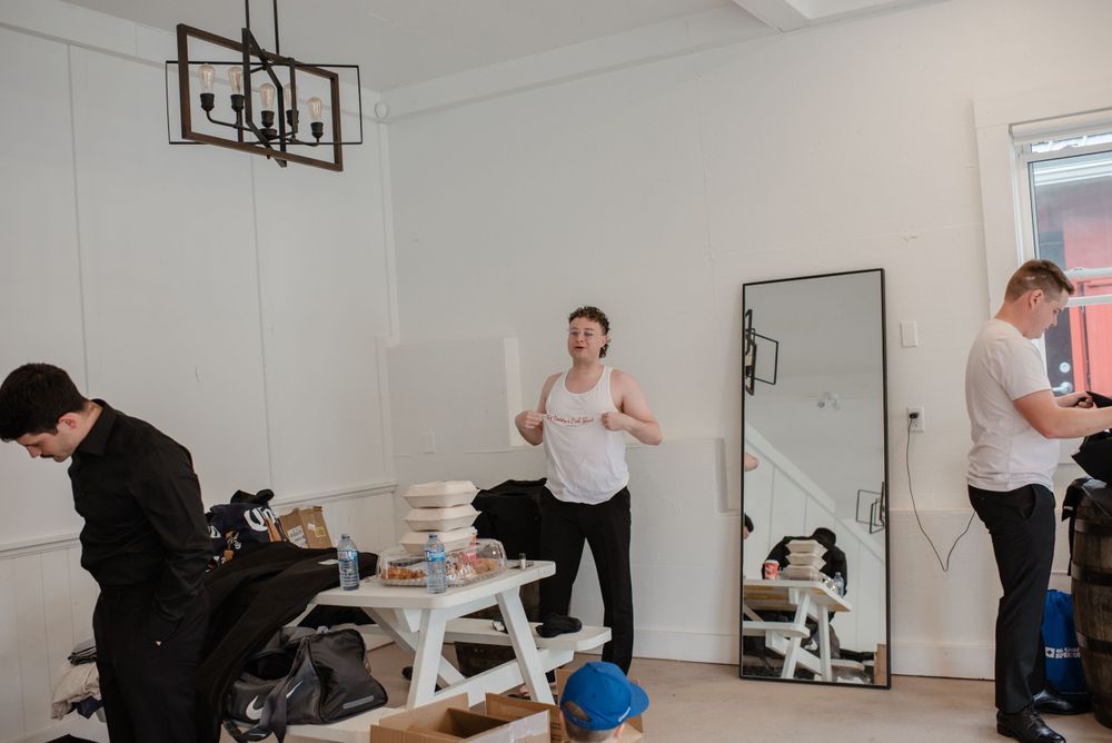 People getting ready in a bright white room with casual atmosphere and modern decor.
