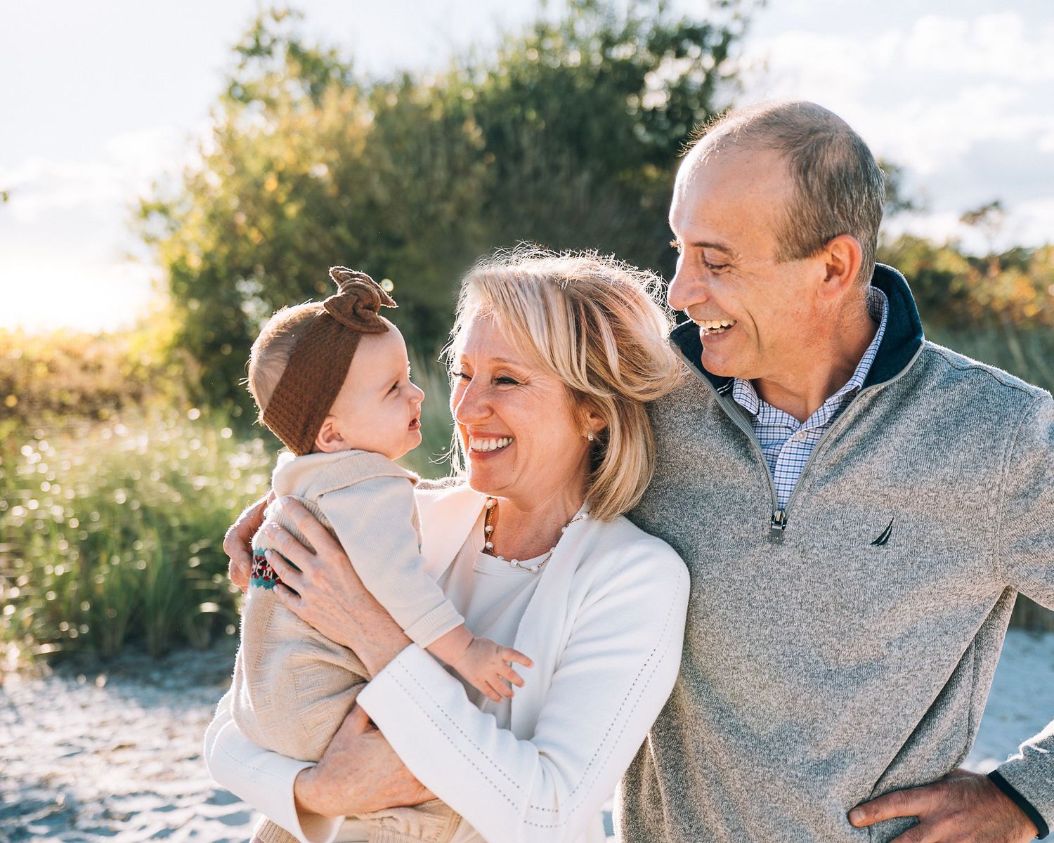 A cheerful family enjoys precious moments together on a sunny day at the beach.