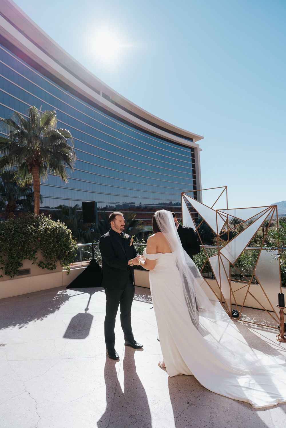 A dreamy panoramic sequence shows a bride's flowing veil gracefully twirling against a modern glass building backdrop.