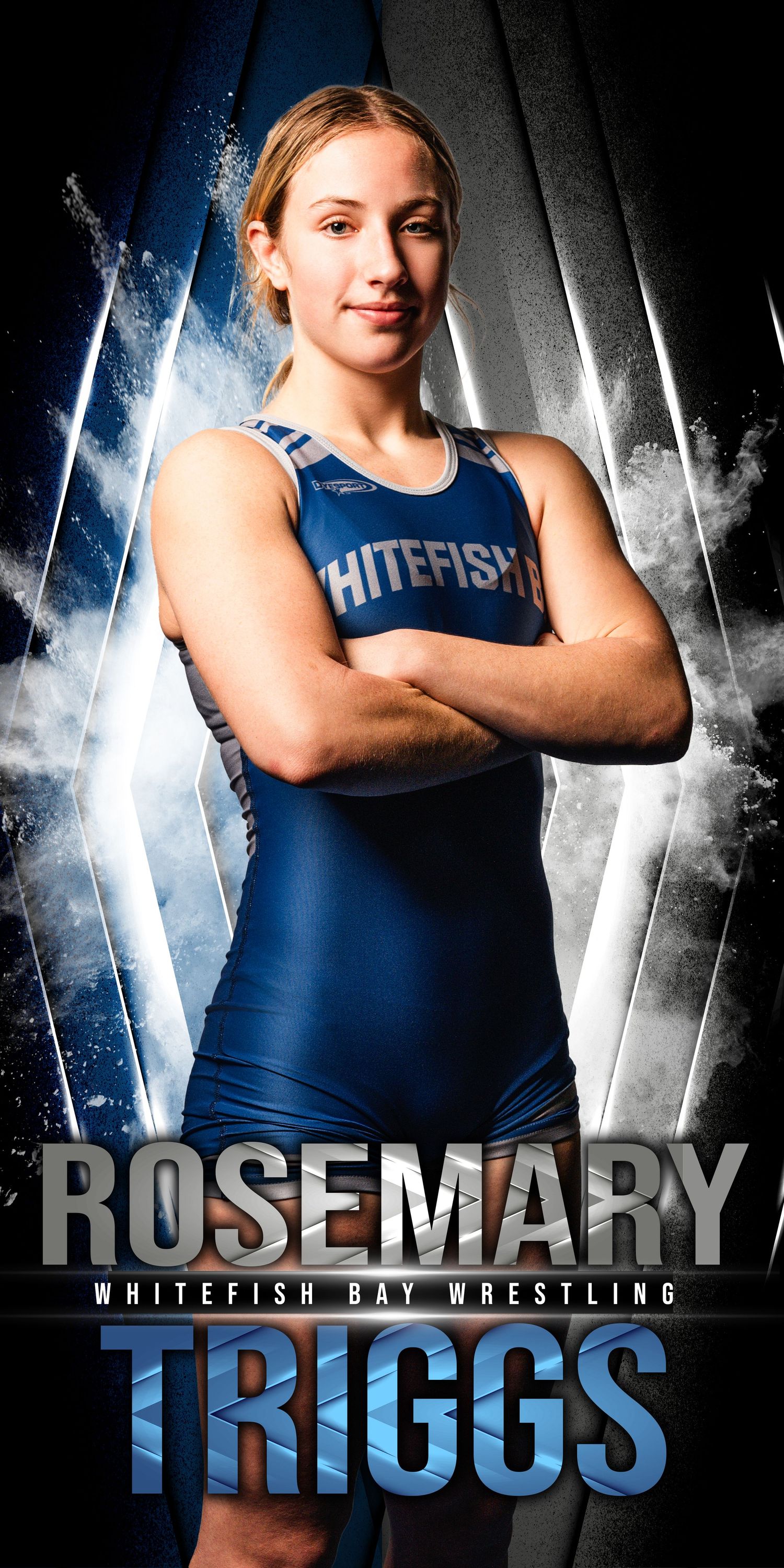 Athletic wrestler in blue Whitefish Bay uniform poses with crossed arms against dramatic light and dark background.