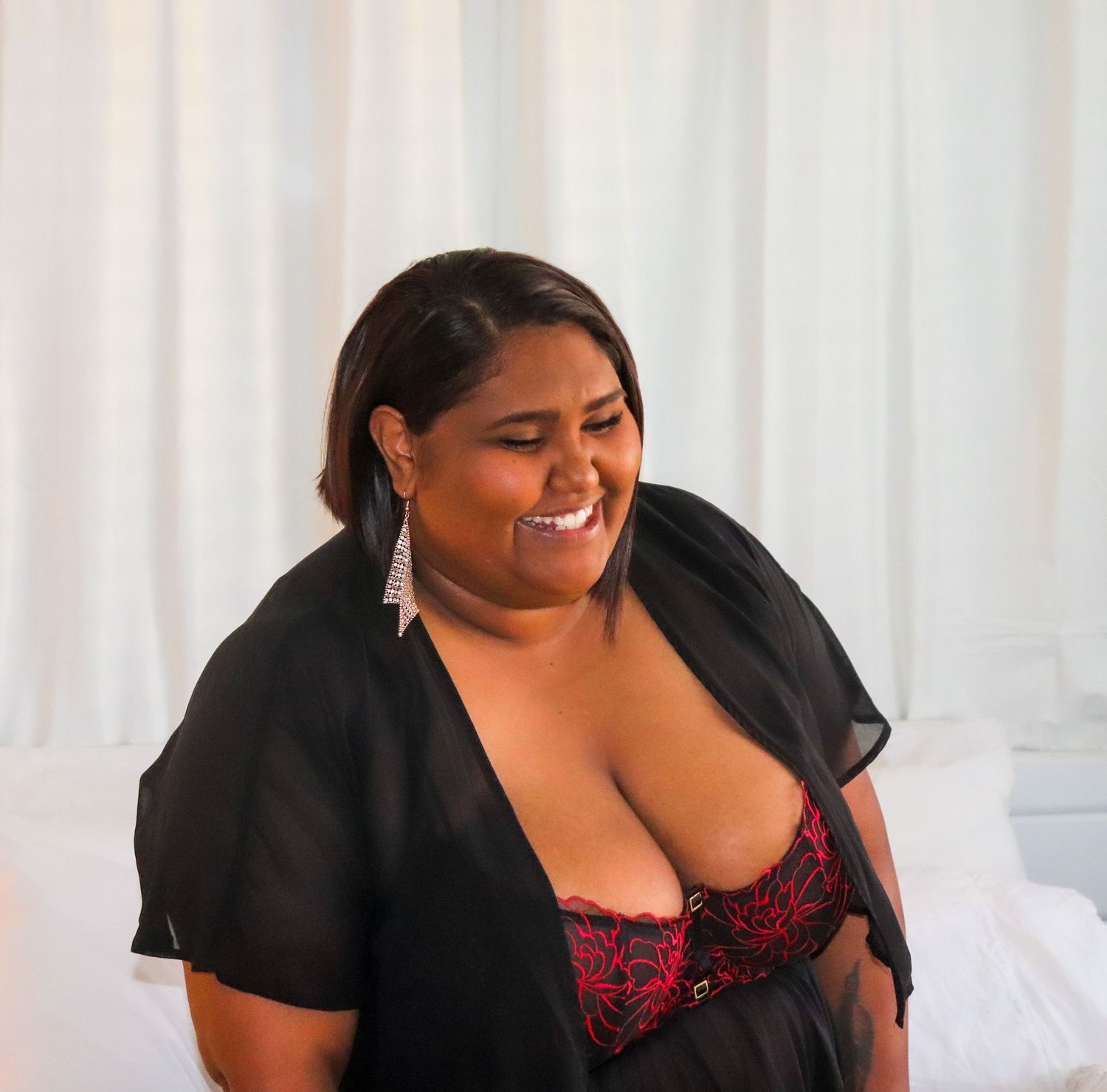A woman posing for a boudoir photo