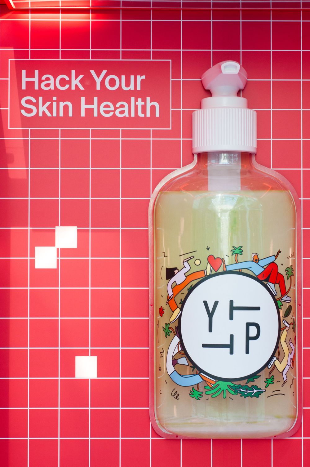 A skincare bottle with 'YP' logo displayed against a red tiled background with text reading 'Hack Your Skin Health'.
