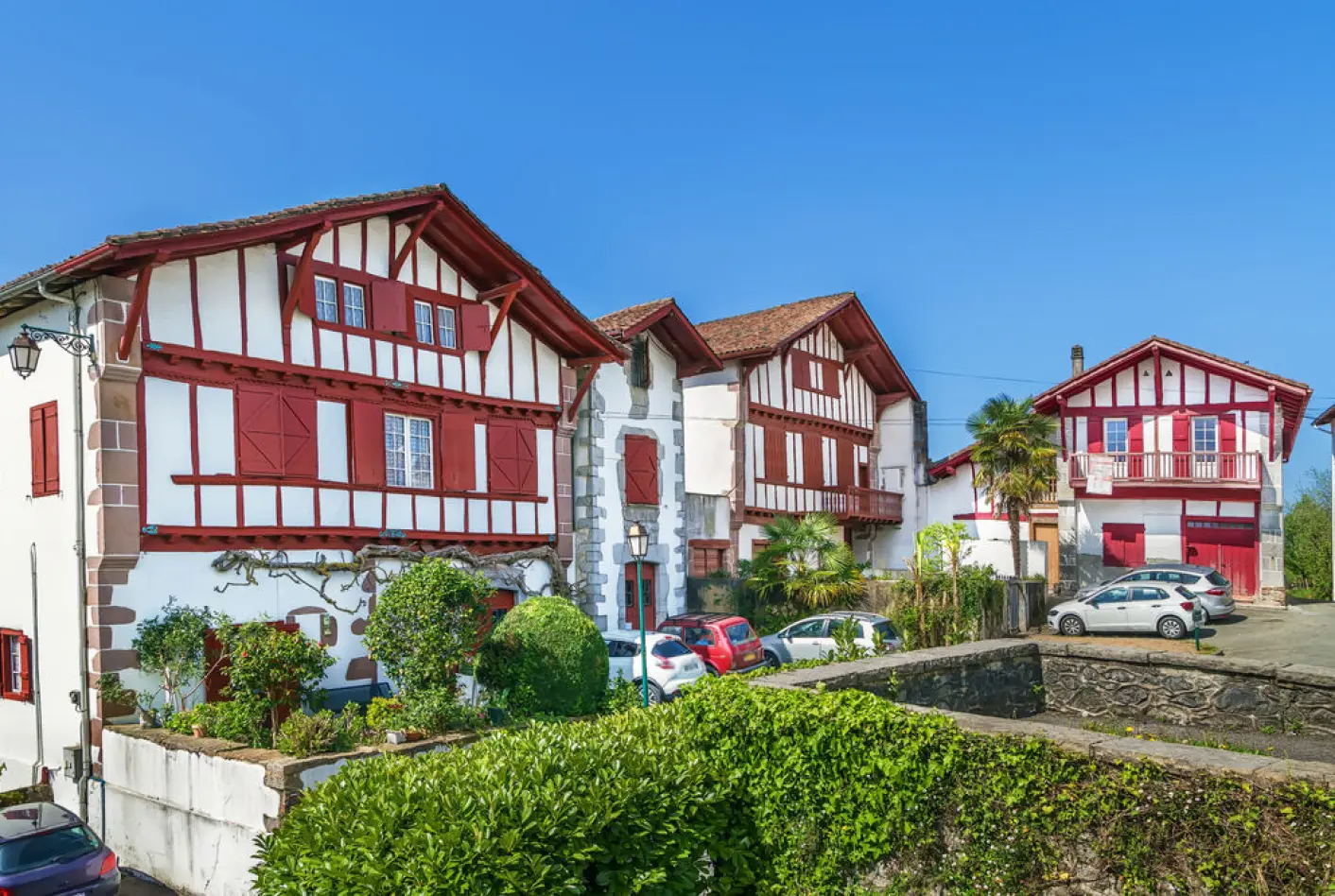 Traditional Basque houses with red and white timber-framing architecture in Ainhoa, French Pyrenees.