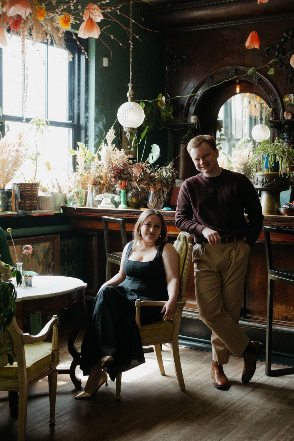 Couple pose in a moody vintage-style cafe interior.
Engagement photoshoot in Denver Colorado