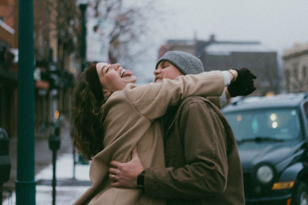 Colorado's winter photoshoot on Colorado Springs downtown. Couple have fun with snow.