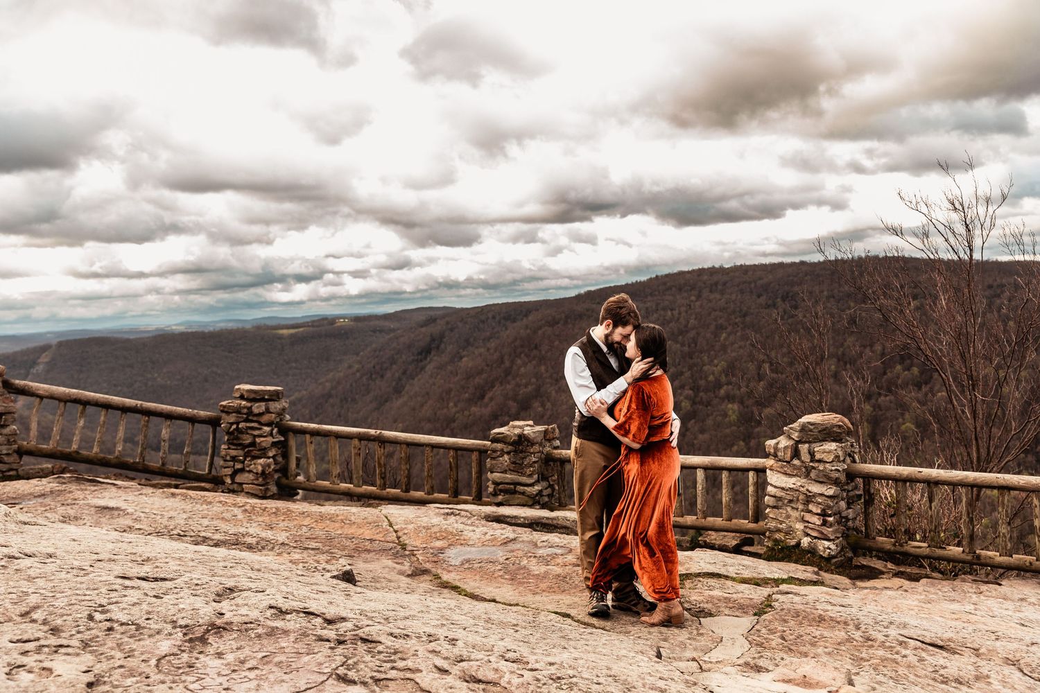 WV engaged couple embrace at Coopers Rock State Park