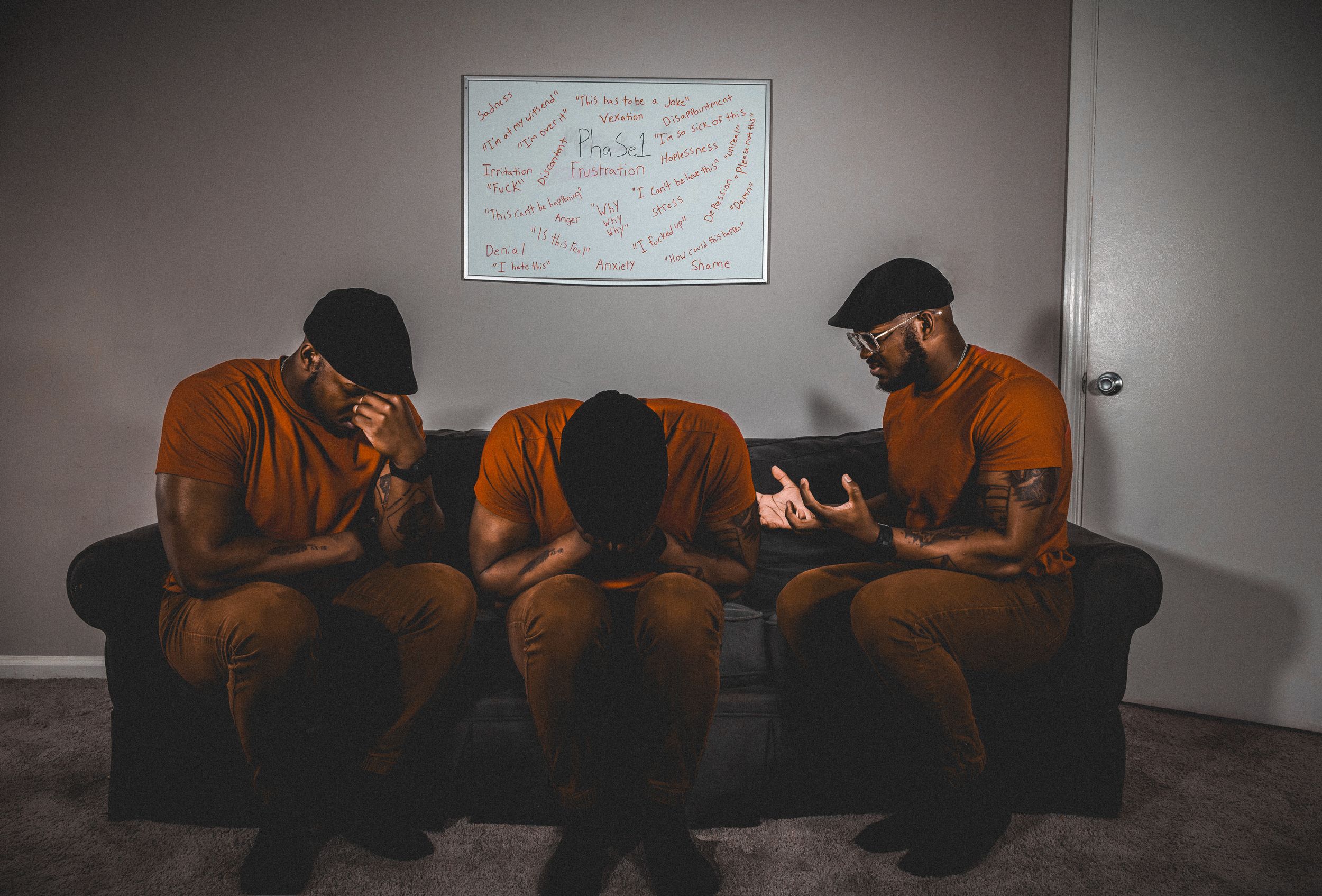 A sepia-toned panoramic view of people sitting on couches absorbed in their mobile devices.