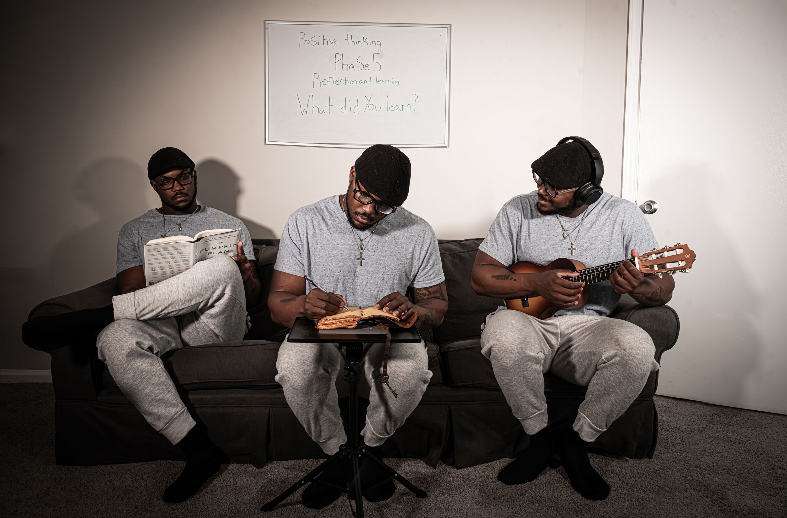 People sitting in a white room looking down at their phones with vignette lighting effects.