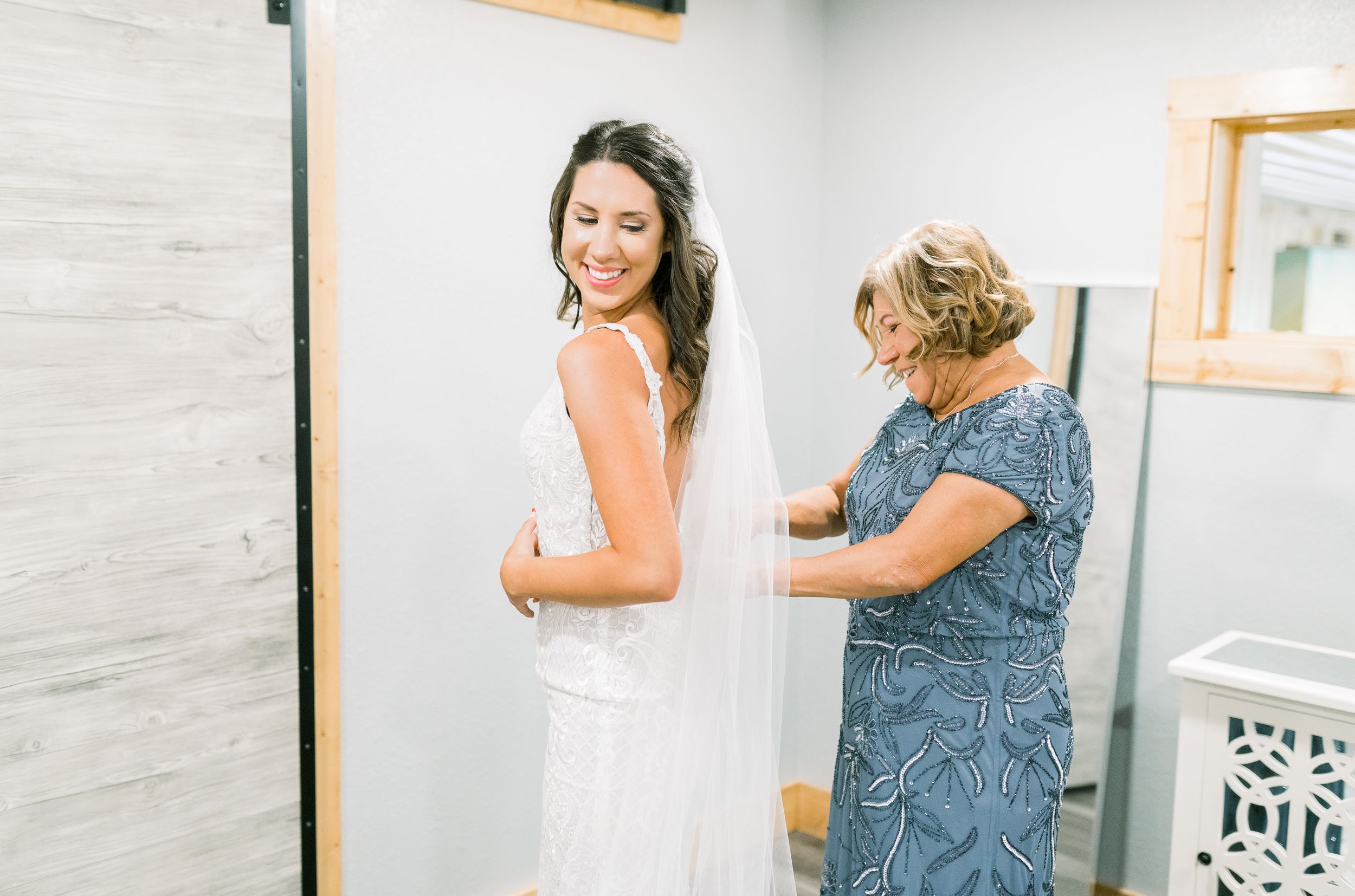Getting ready dress zipping photos in at Prairie Moon Winery wedding in Ames, Iowa
