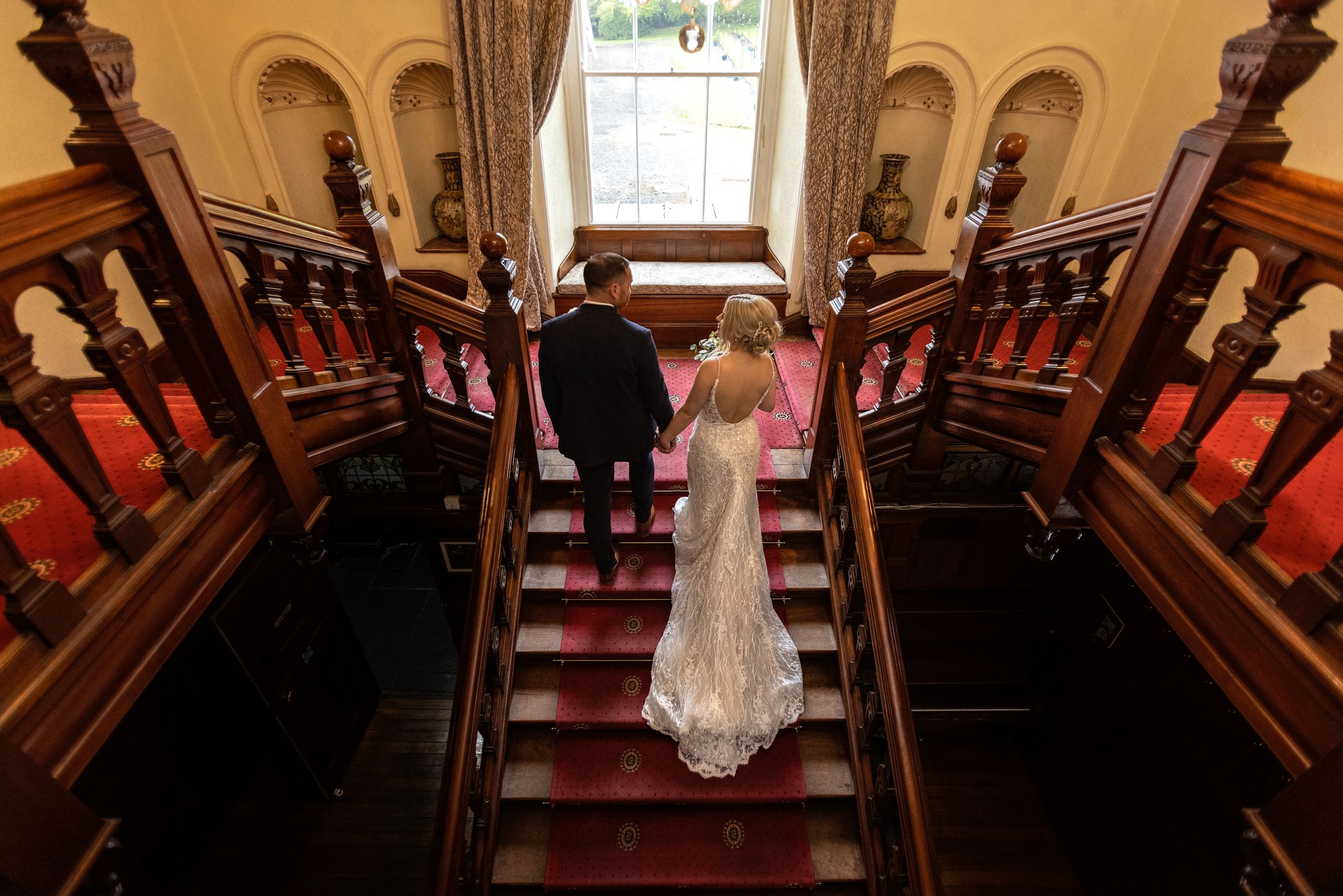 beautiful back of the wedding dress on stairs at Court Colman