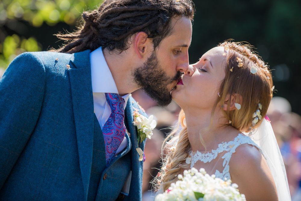 Bride and groom kissing rustic wedding
